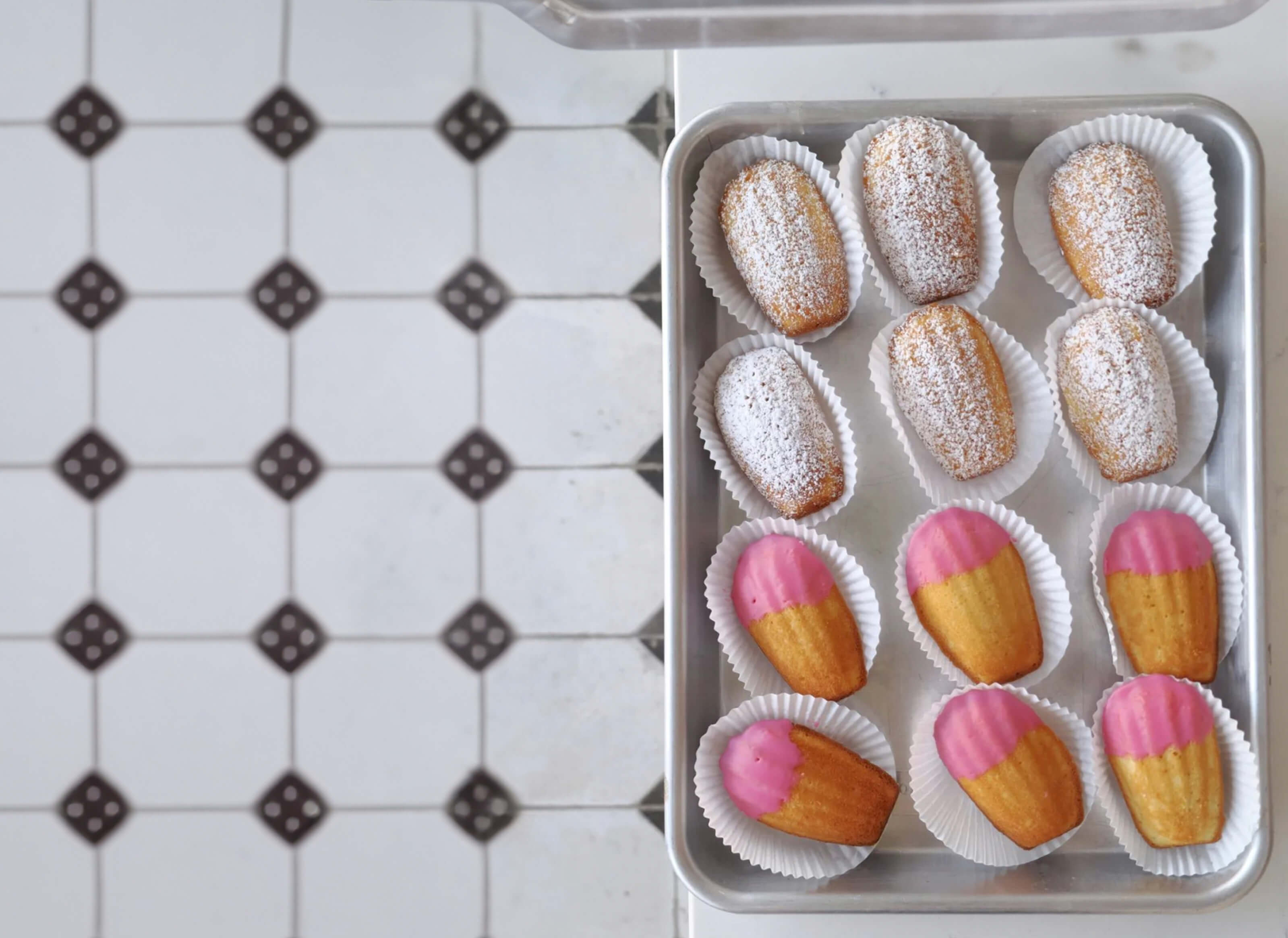 Aerial view of Manvir Bakes cupcakes on a white tray in a kitchen